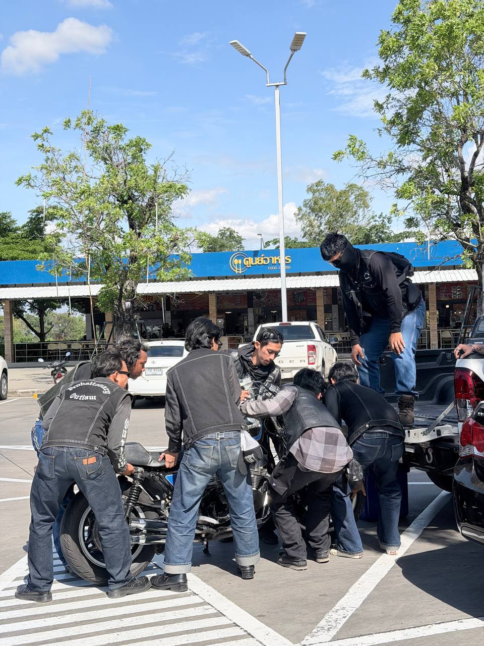 S.Y.L.O. and Probate loading a motorcycle onto the service truck during the Outlaws MC Thailand Family Run.